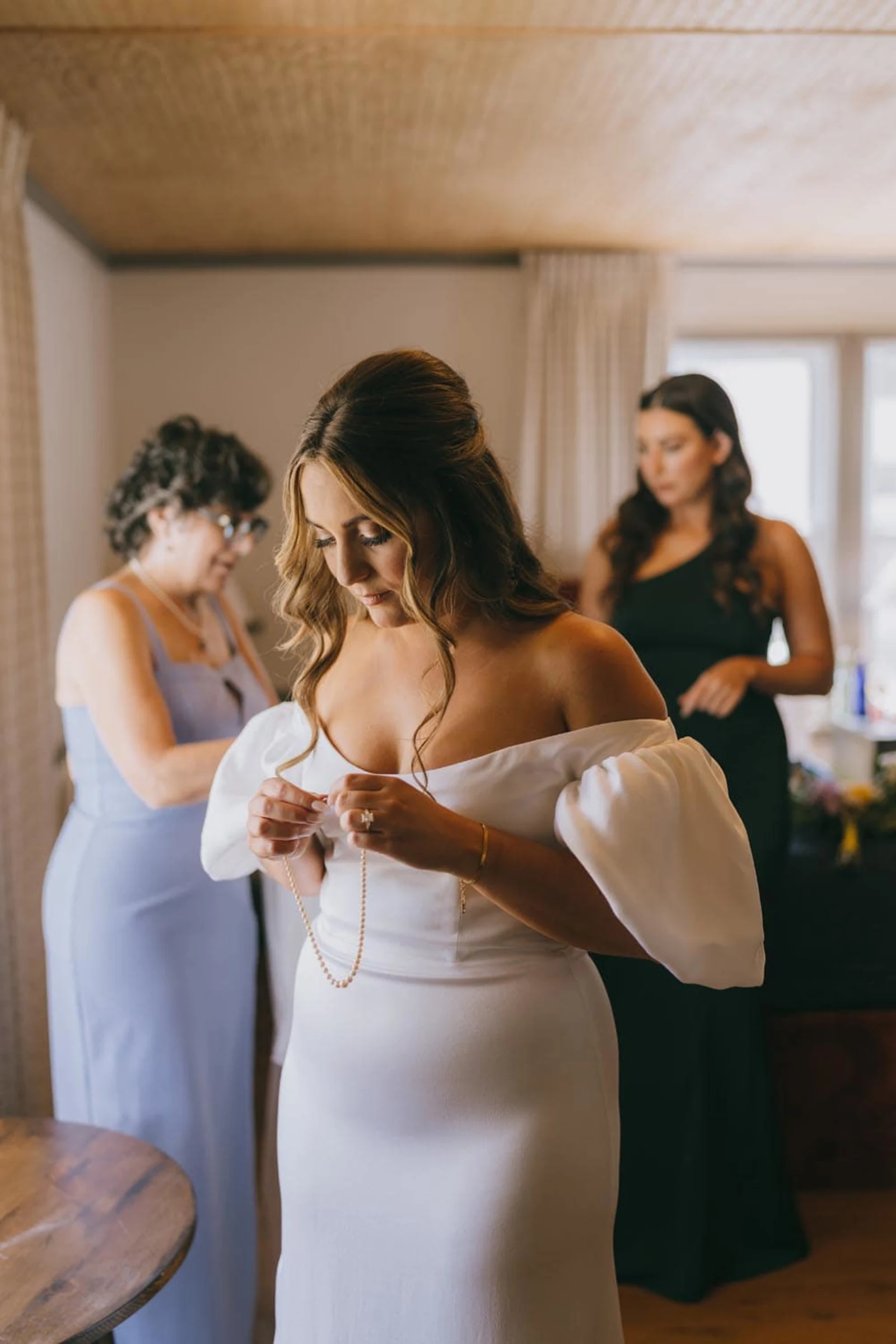 Bride preparing with bridesmaids on her wedding day at the Wylder Hotel, Hudson Valley