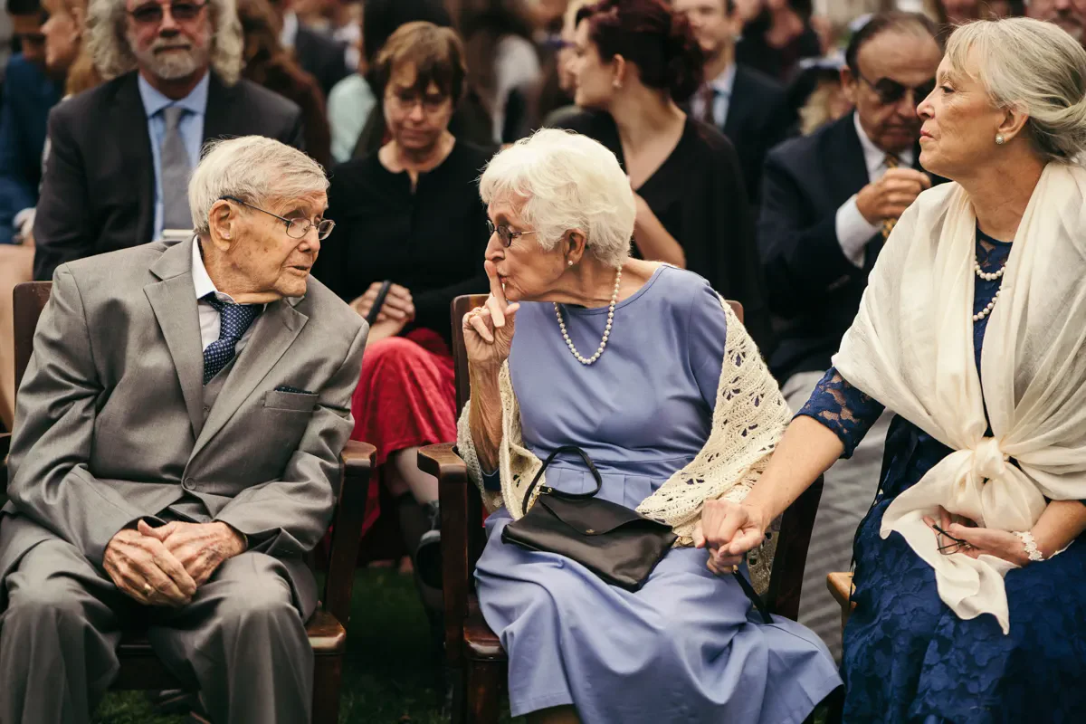 Elderly wedding guests sharing a warm moment while seated together during the Hudson Valley wedding reception