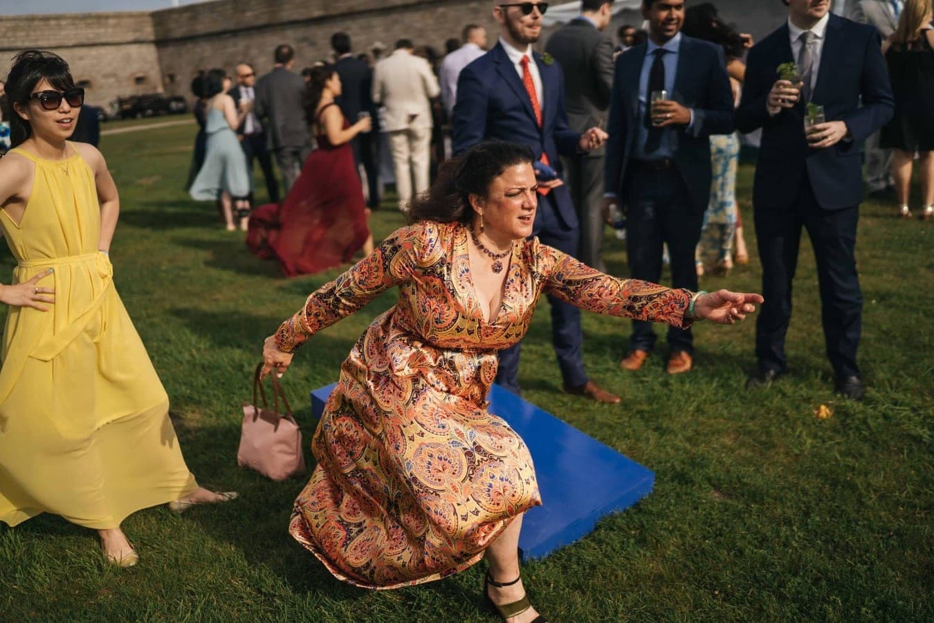 Woman plays hacky-sack during wedding reception in Rhode Island.