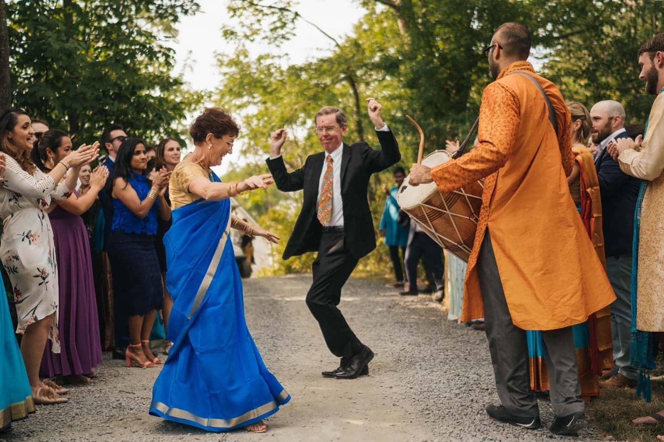 Groom's parents dance to Indian drum player before wedding ceremony at Cedar Lakes Estate in the Catskills.
