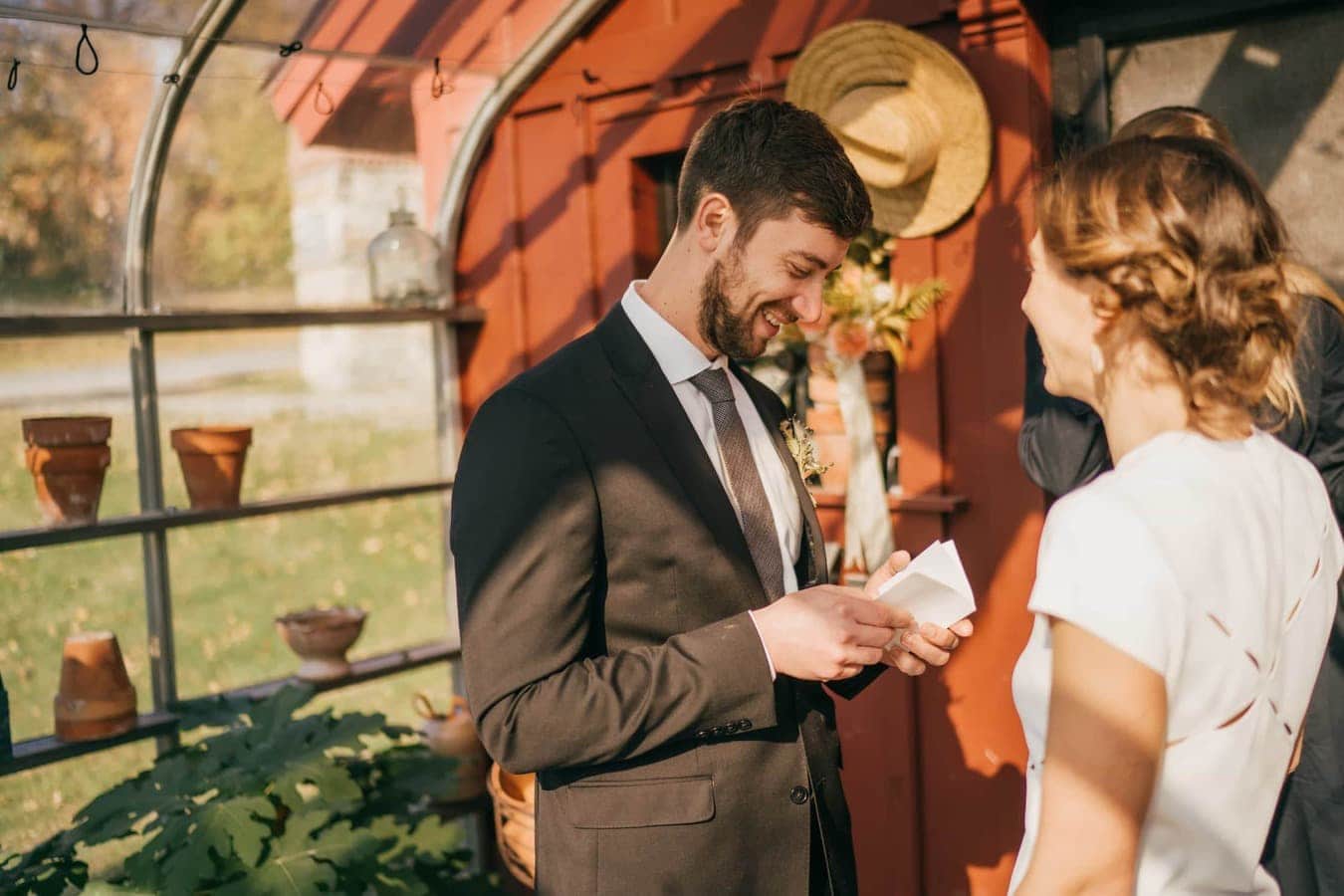 Groom reads wedding vows to bride during ceremony in Catskills.