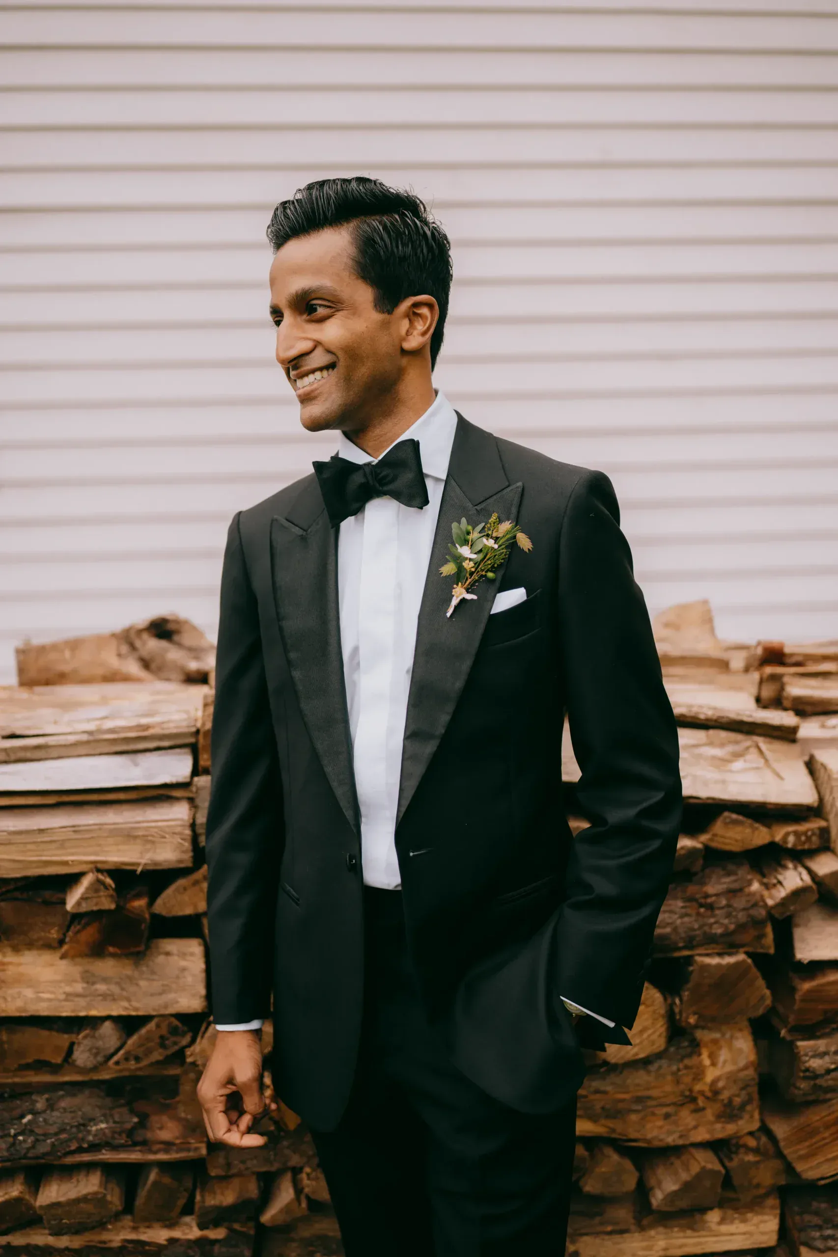 Groom standing tall in an elegant suit
