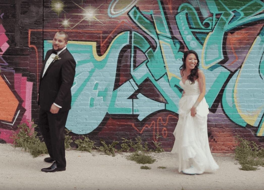 Bride and groom first look against vibrant graffiti background