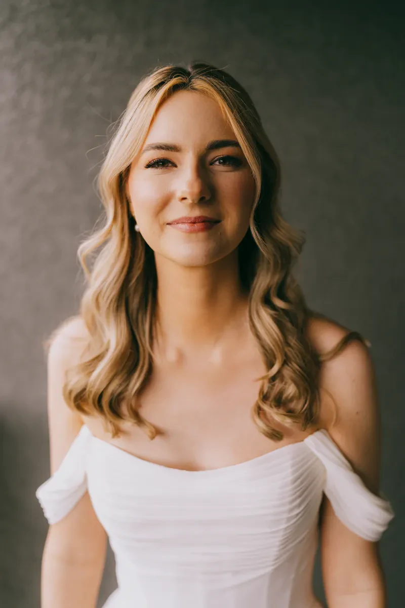 Bride in an off-the-shoulder white gown smiling softly during portraits at Blooming Hill Farm, Hudson Valley