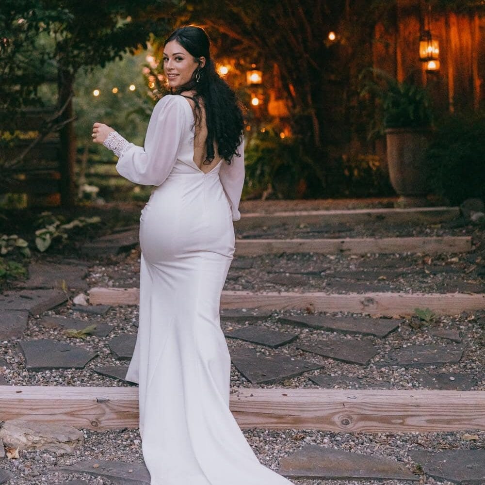 Woman in white dress at twilight garden party