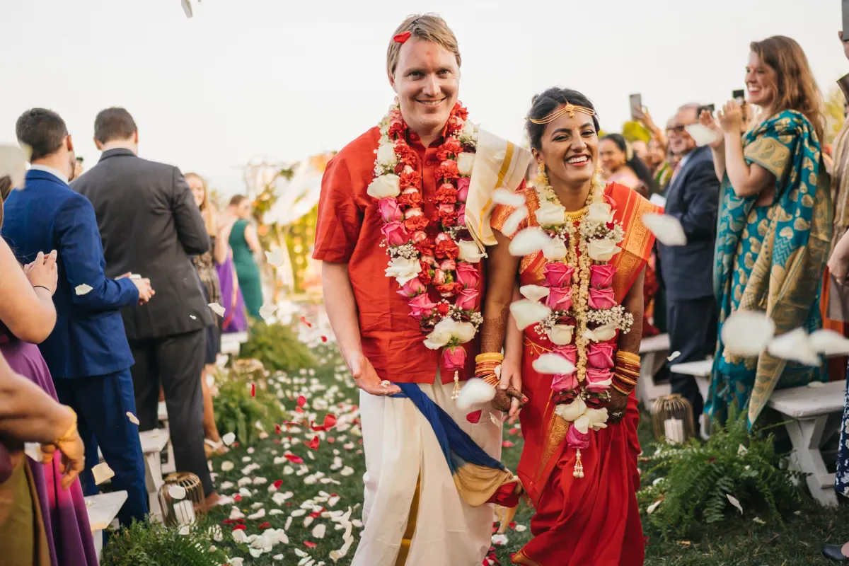 Guests in vibrant traditional attire and flower garlands celebrating a South Asian wedding ceremony at Cedar Lakes Estate, Hudson Valley