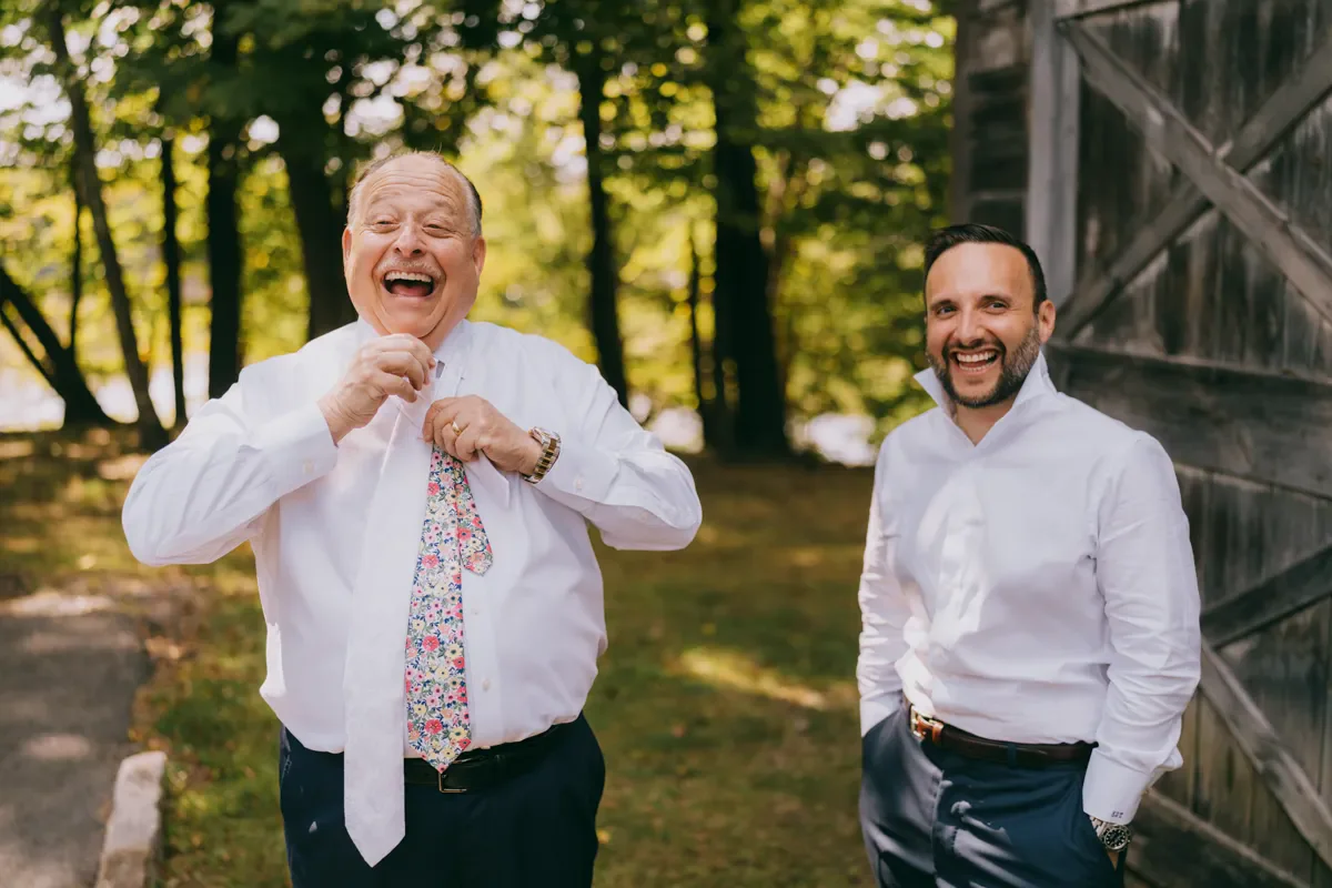 Groom laughing with joy during portraits at City Winery wedding, Hudson Valley