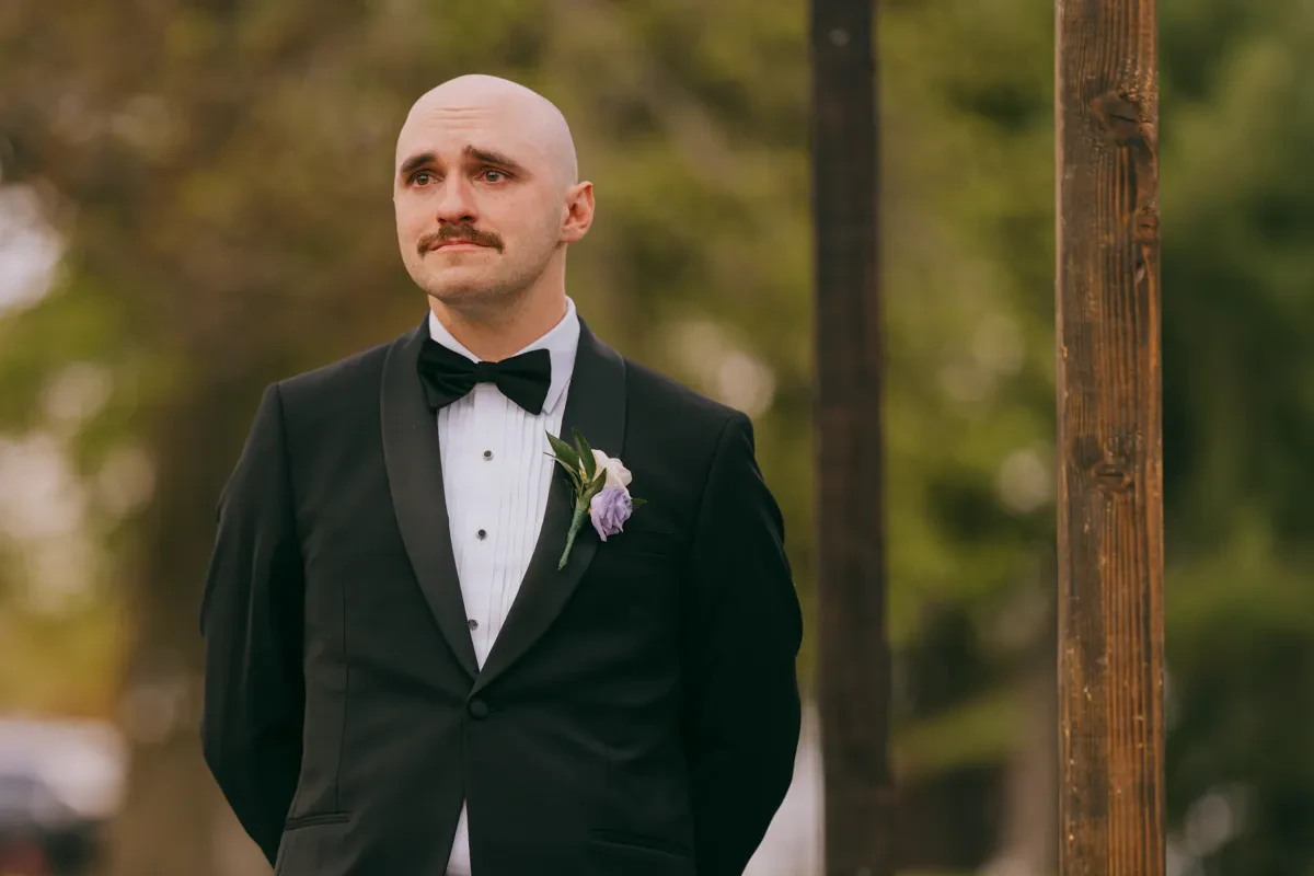 Close-up portrait of groom in a classic tuxedo with a white boutonniere at Tarrytown Estate wedding, Hudson Valley